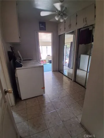 a living room with a couch and a chandelier
