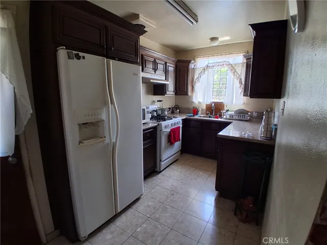 a kitchen with a refrigerator and a sink