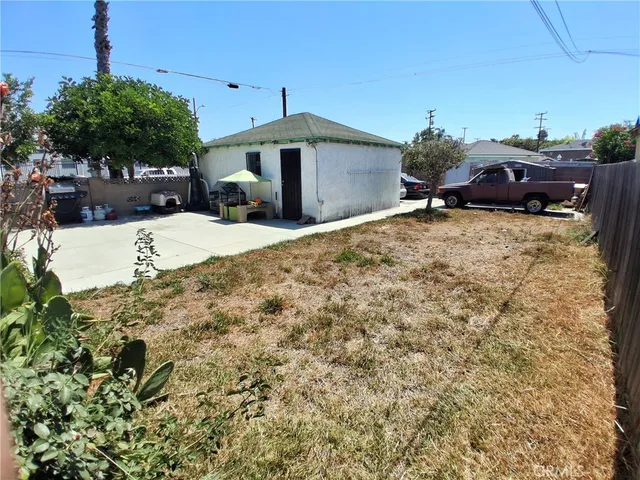 a view of a house with a yard and sitting area