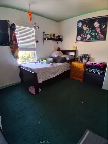 a bedroom with furniture and window