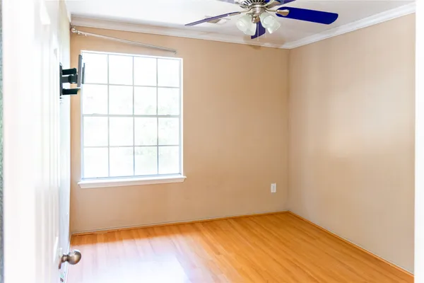 a view of a room with a window and wooden floor