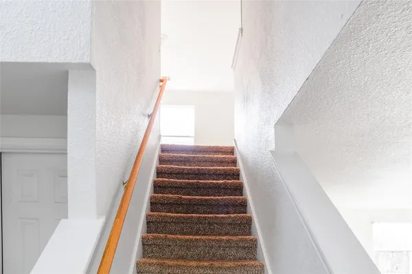a view of a room with wooden floor and a fence