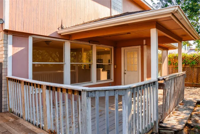 a view of a room with wooden floor and a fence