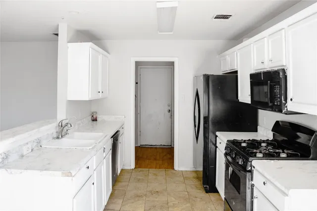 a kitchen with a sink stove and refrigerator
