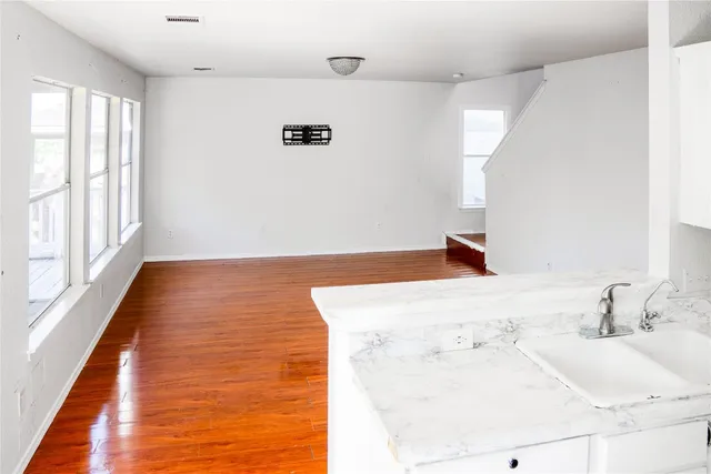 a kitchen with a stove a refrigerator and a sink
