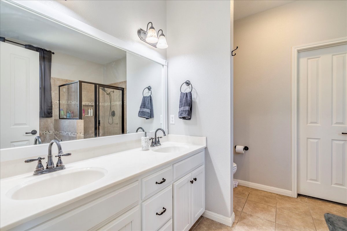 11 Rhapsody Lane Wimberley, TX 78676 - Photo 14 of 35 a bathroom with a double vanity sink mirror and