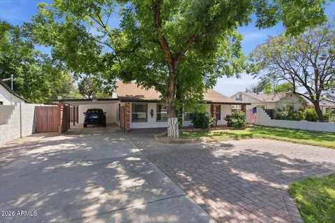 a front view of a house with patio and garden