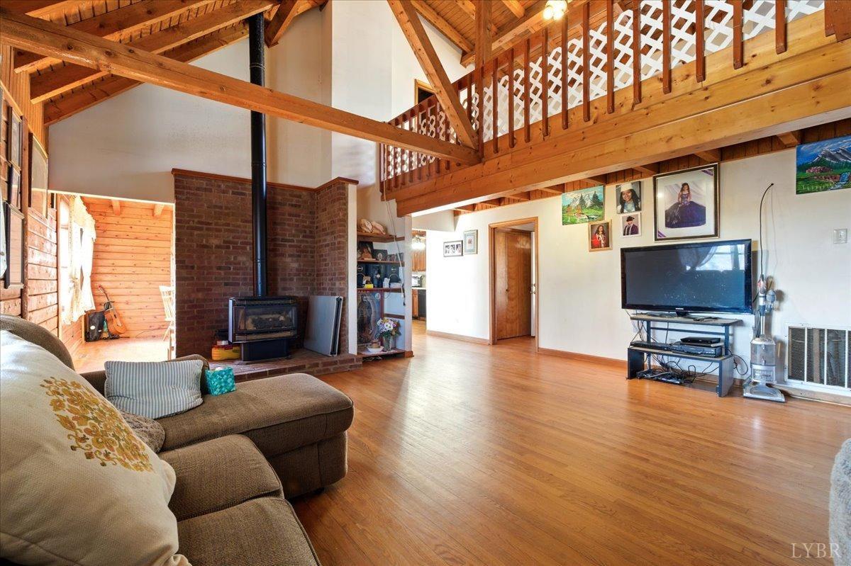2192 Hixburg Road Pamplin, VA 23958 - Photo 8 of 31 a living room with furniture a flat screen tv and a fireplace