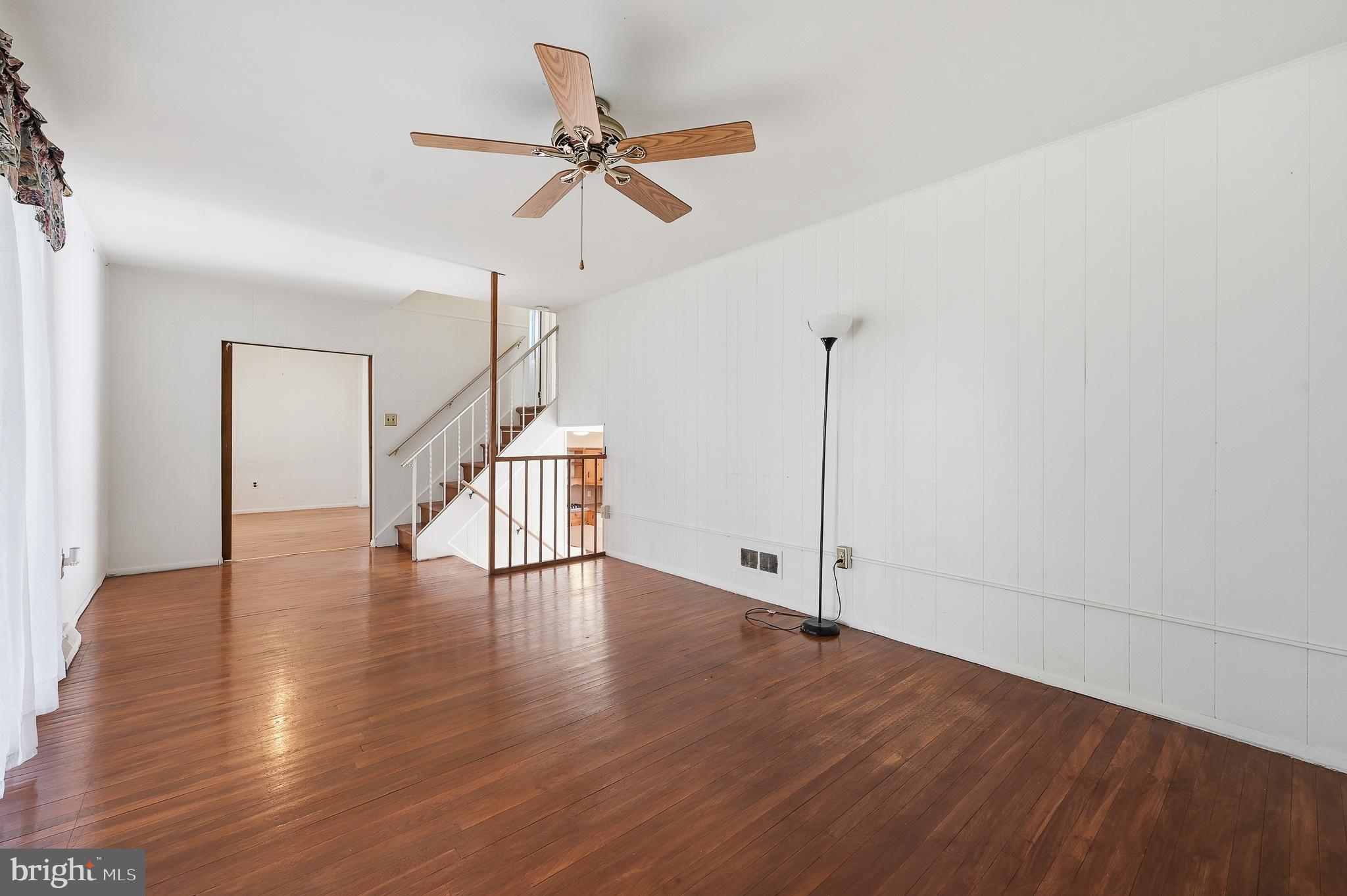 406 Blackstone Road Newark, DE 19713 - Photo 14 of 27 a view of an empty room with wooden floor and a ceiling fan