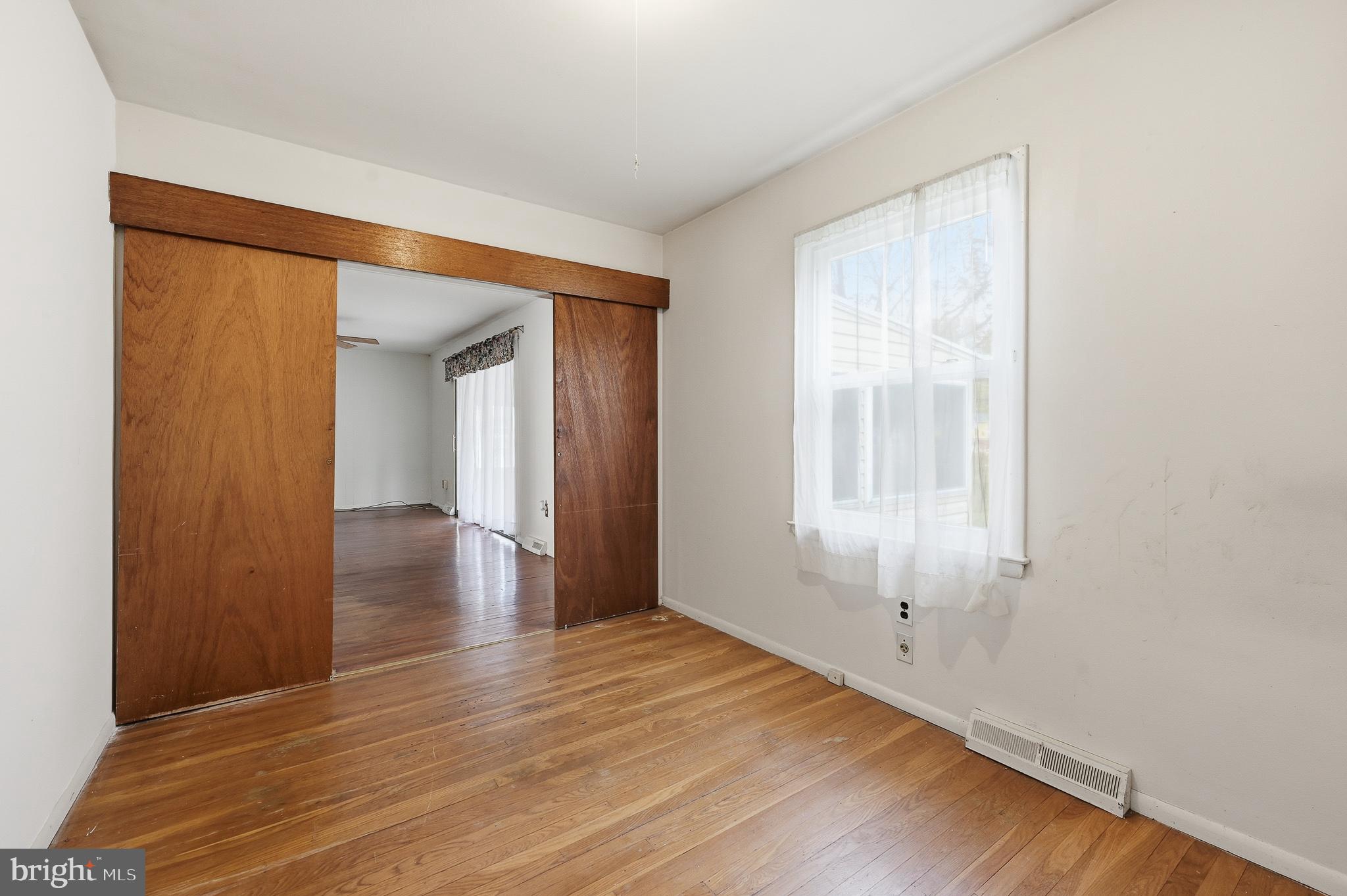 406 Blackstone Road Newark, DE 19713 - Photo 21 of 27 a view of an empty room with wooden floor and a window