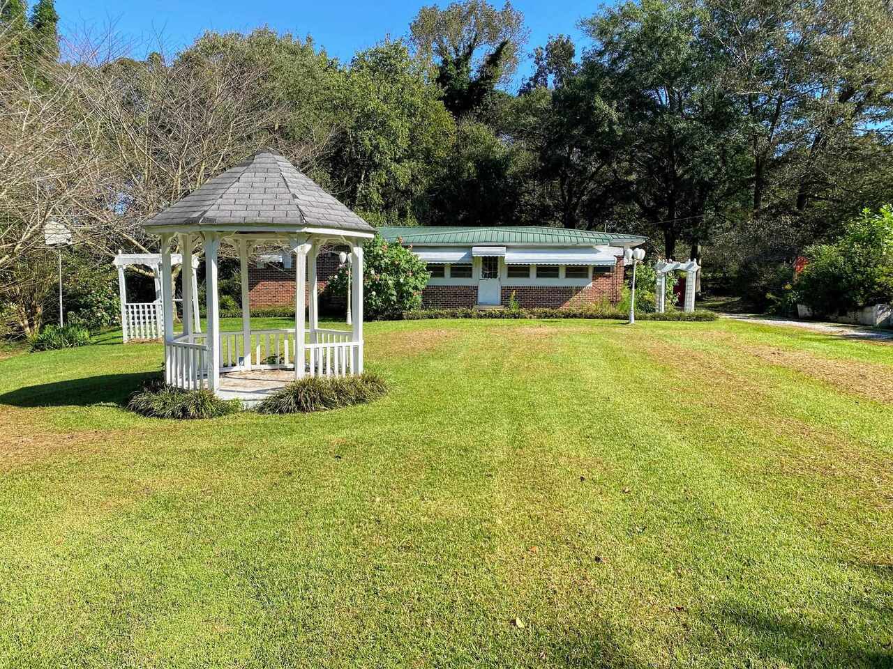 a front view of a house with a yard table and chairs