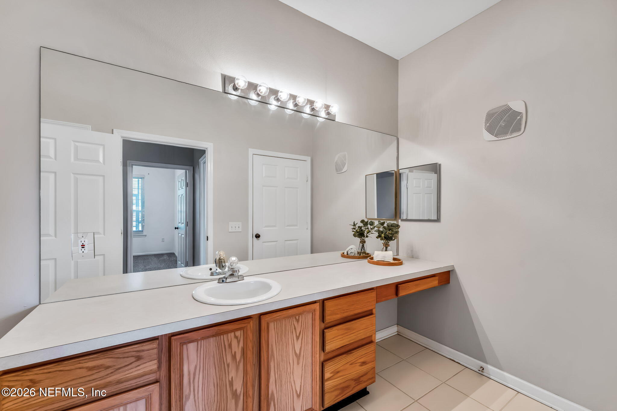 7990 Baymeadows Road East, Unit 520 Jacksonville, FL 32256 - Photo 22 of 41 a bathroom with a sink and a mirror