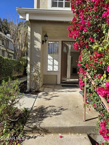 an empty room with windows and fireplace