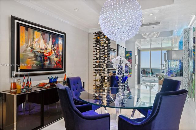 a living room with furniture and a painting on the wall