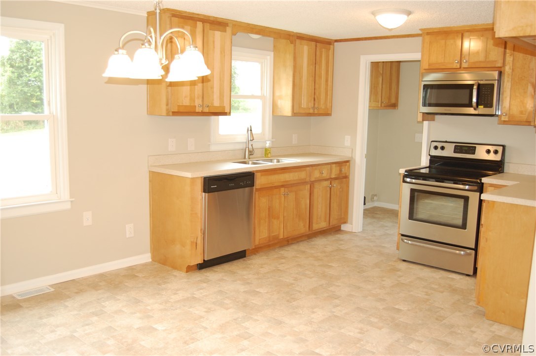 1509 Mc Cune Road Crewe, VA 23930 - Photo 5 of 18 a kitchen with stainless steel appliances granite countertop a stove a sink and a microwave