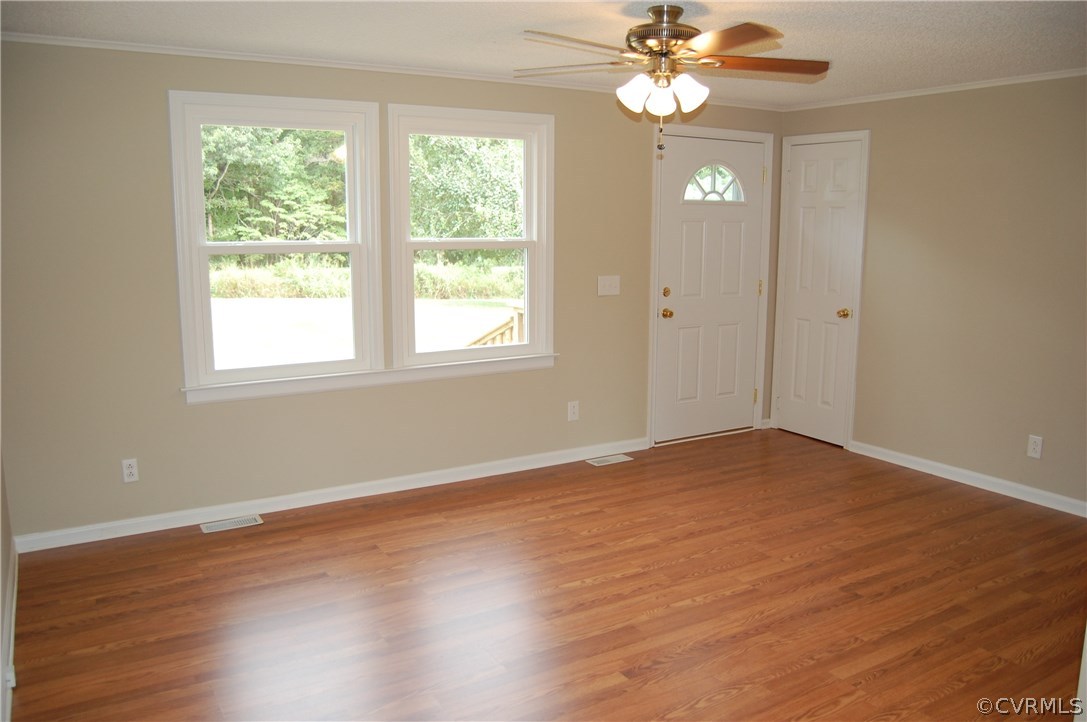 1509 Mc Cune Road Crewe, VA 23930 - Photo 10 of 18 a view of an empty room with wooden floor and a window