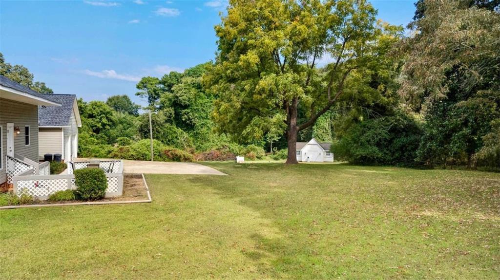 148 Simmons Street Trion, GA 30753 - Photo 15 of 73 a view of a large yard with an outdoor space and seating area