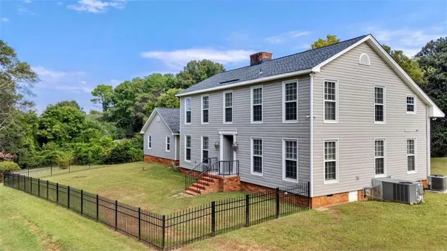 a view of a house with swimming pool and a yard
