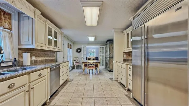 a view of a hallway with wooden cabinets and staircase