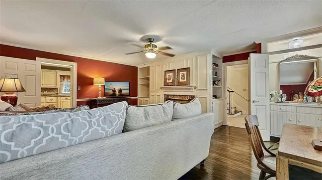 a view of hallway with chandelier and wooden floor