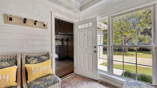 a bedroom with a bed couch and view of living room