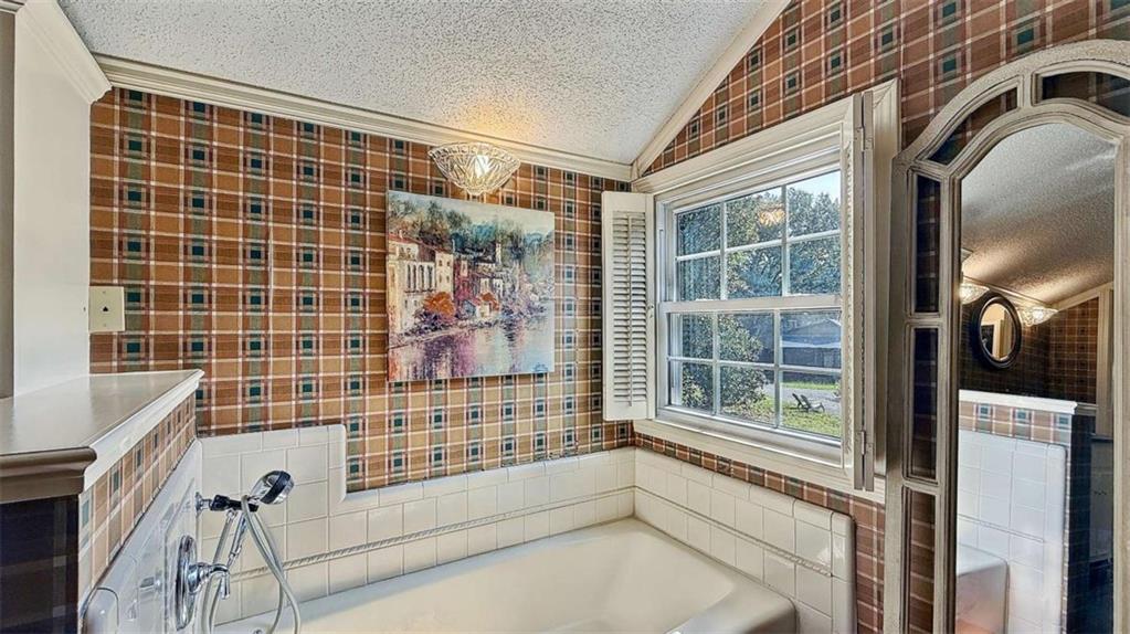 148 Simmons Street Trion, GA 30753 - Photo 41 of 73 a bathroom with a bathtub and next to a window