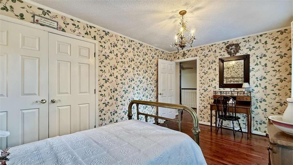 148 Simmons Street Trion, GA 30753 - Photo 50 of 73 a bedroom with a bed and a chandelier