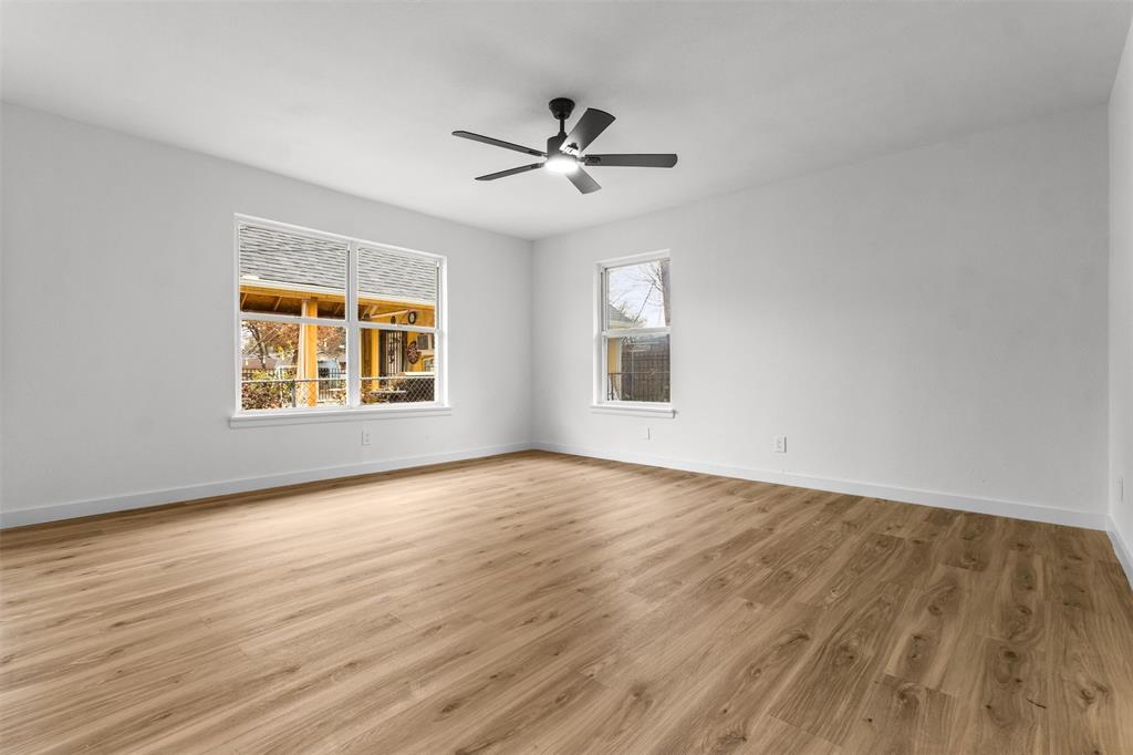 1917 South Vernon Avenue Dallas, TX 75224 - Photo 23 of 28 Spacious room featuring wood-finish flooring, white walls, and a contemporary ceiling fan with integrated lighting