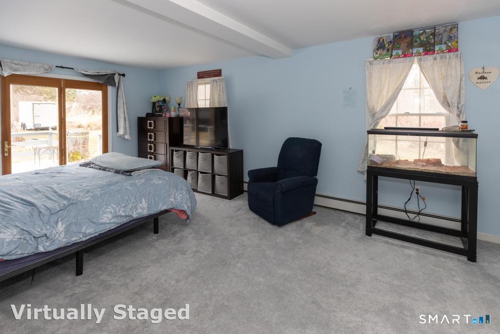 36 Music Vale Road Salem, CT 06420 - Photo 15 of 44 The first floor primary suite is super spacious and has slider access to deck . . .