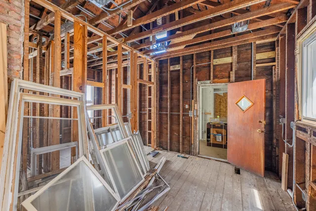a view of an entryway with wooden floor and windows