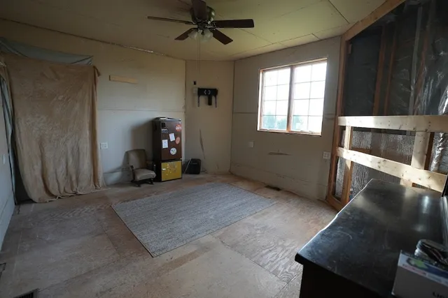 a view of a livingroom with furniture and a window