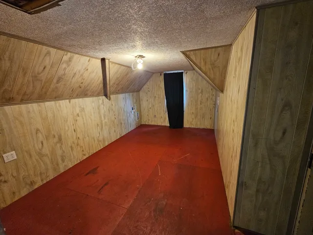 a view of a big room with wooden floor and windows