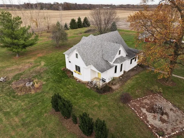 a aerial view of a house with a yard and lake view