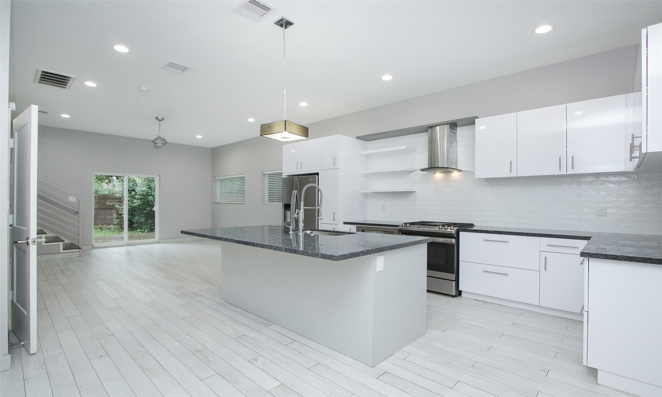 a kitchen with stainless steel appliances granite countertop a sink and a stove top oven