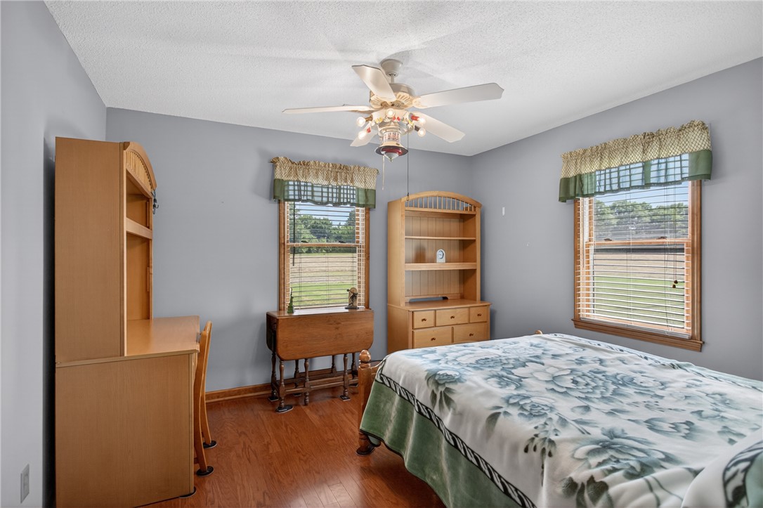 145 State Rd S-4-935 Pendleton, SC 29670 - Photo 45 of 47 Well-lit sleeping quarters with a ceiling fan, wood floors, and views of the surrounding green landscape.