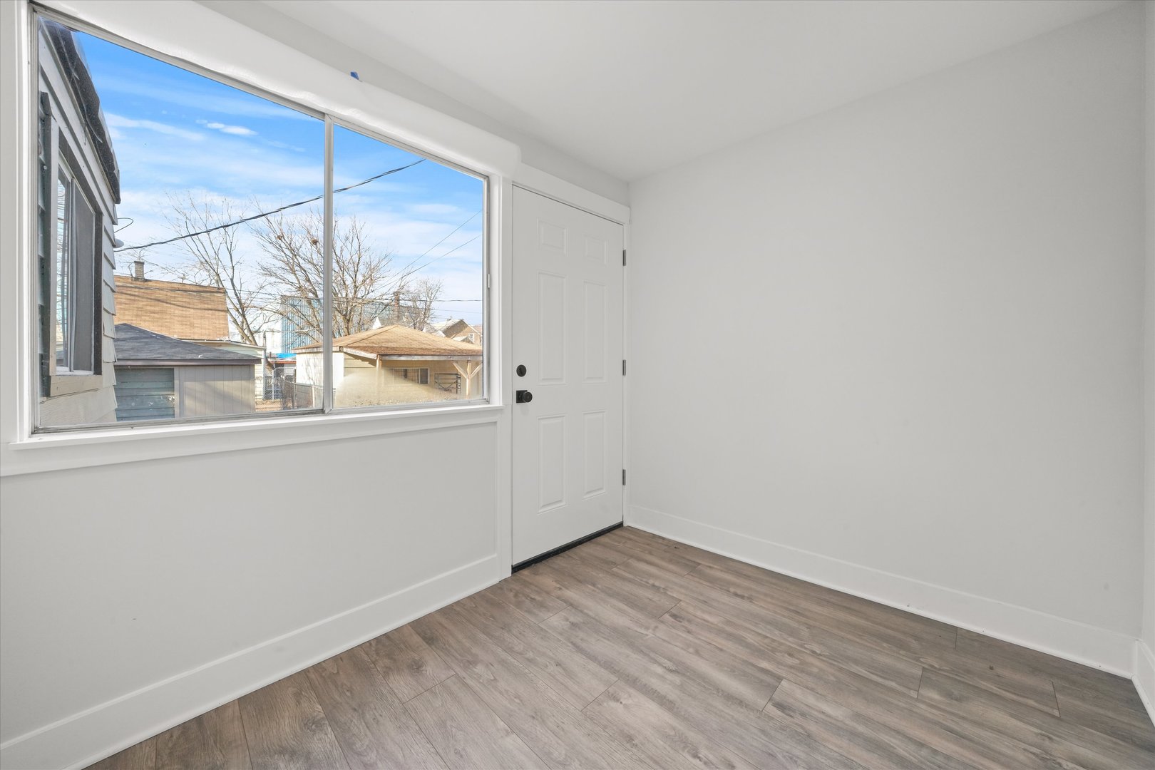 7356 South Kenwood Avenue Chicago, IL 60619 - Photo 11 of 27 a view of empty room with wooden floor and fan