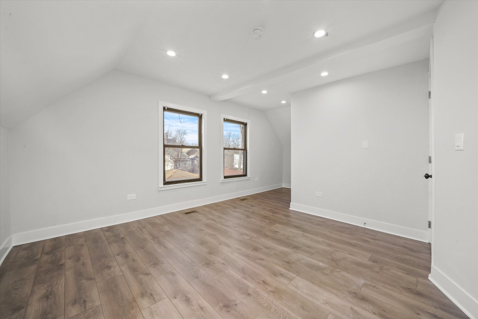 7356 South Kenwood Avenue Chicago, IL 60619 - Photo 14 of 27 a view of an empty room with window and wooden floor