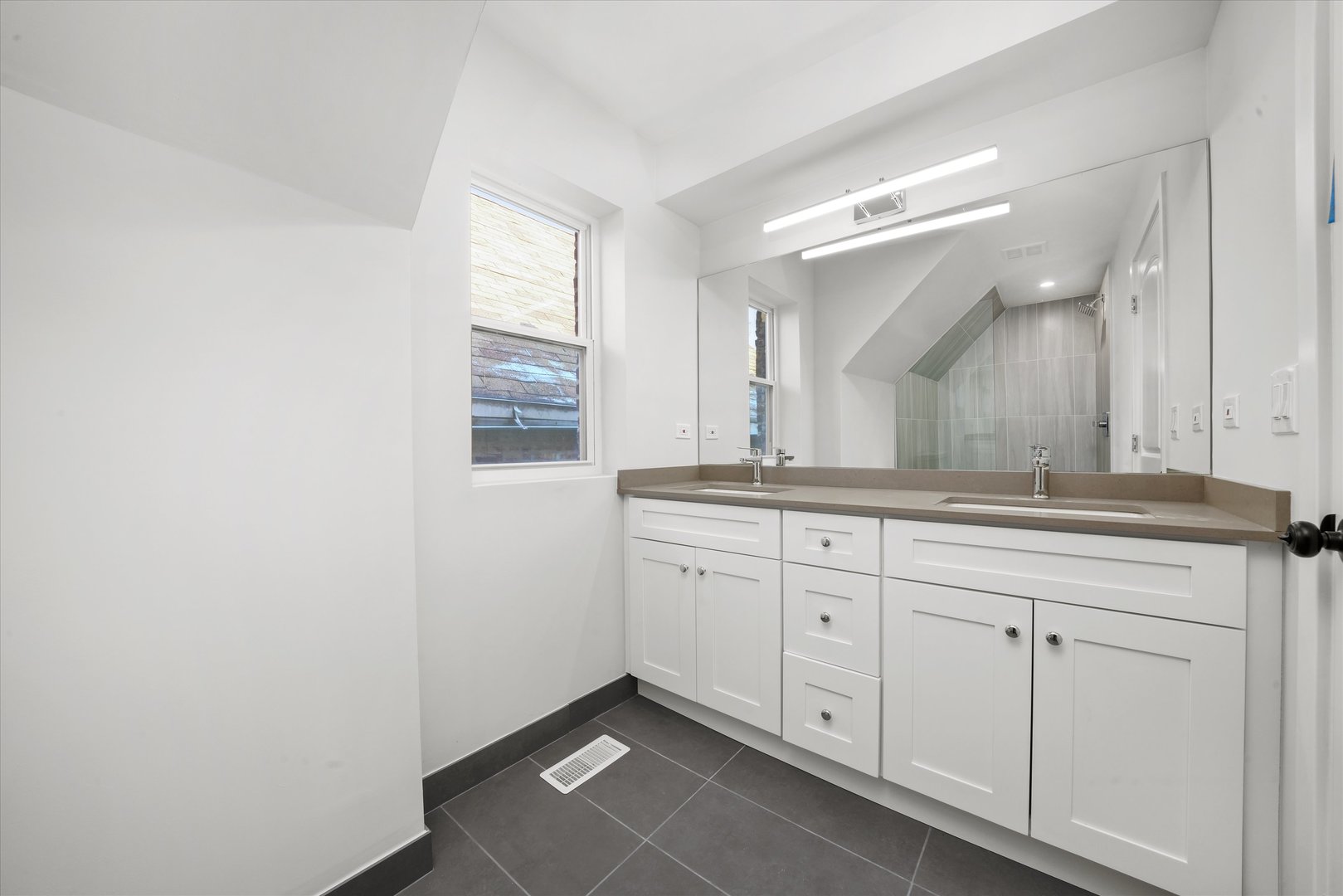 7356 South Kenwood Avenue Chicago, IL 60619 - Photo 17 of 27 a spacious bathroom with a granite countertop sink and a mirror