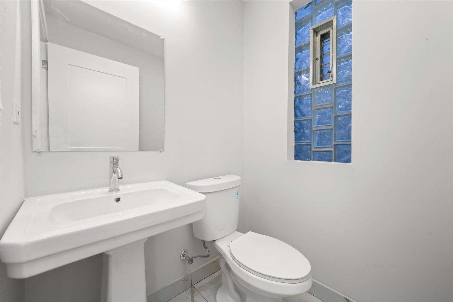 7356 South Kenwood Avenue Chicago, IL 60619 - Photo 20 of 27 a bathroom with a toilet a sink and mirror
