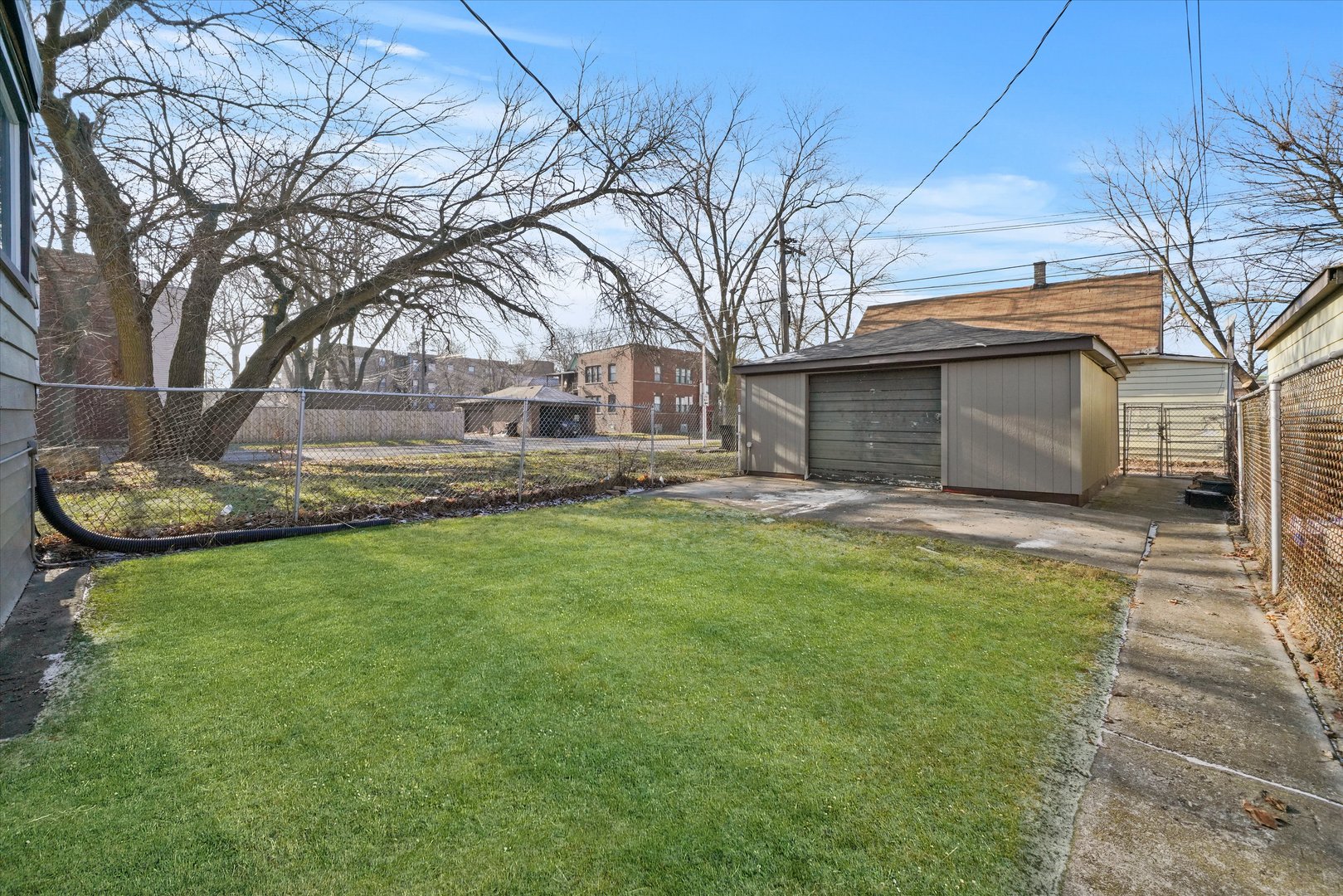 7356 South Kenwood Avenue Chicago, IL 60619 - Photo 24 of 27 a front view of a house with a garden