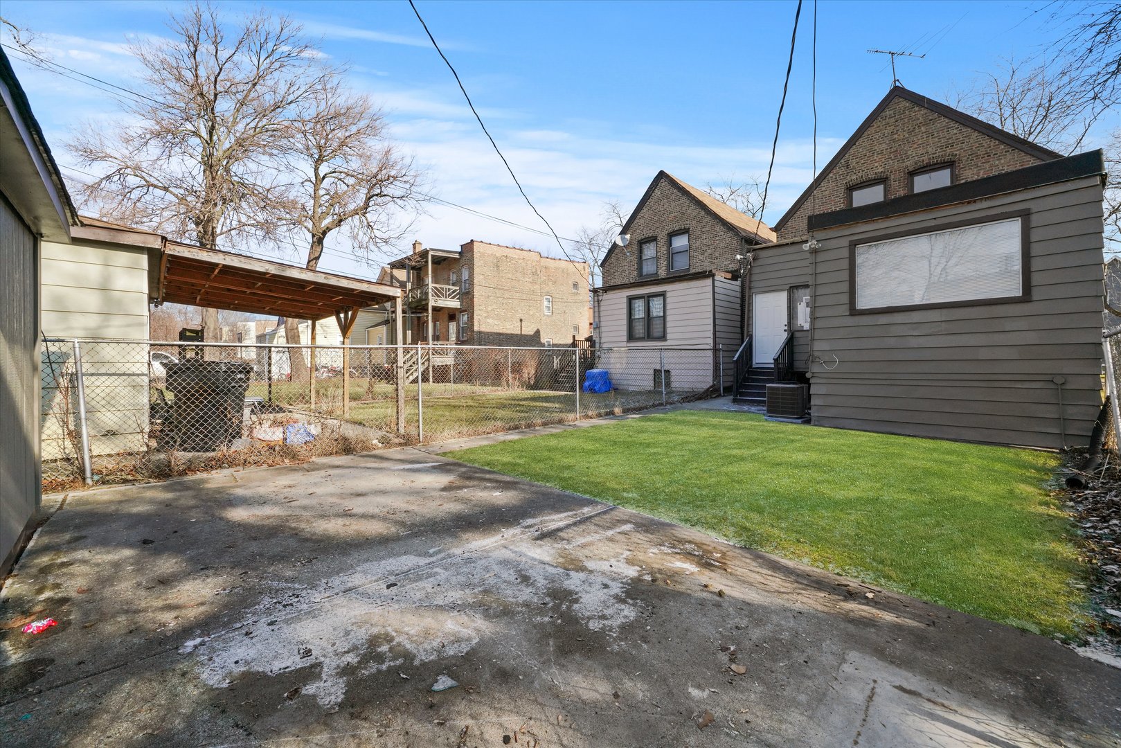 7356 South Kenwood Avenue Chicago, IL 60619 - Photo 26 of 27 a front view of a house with a yard and garage