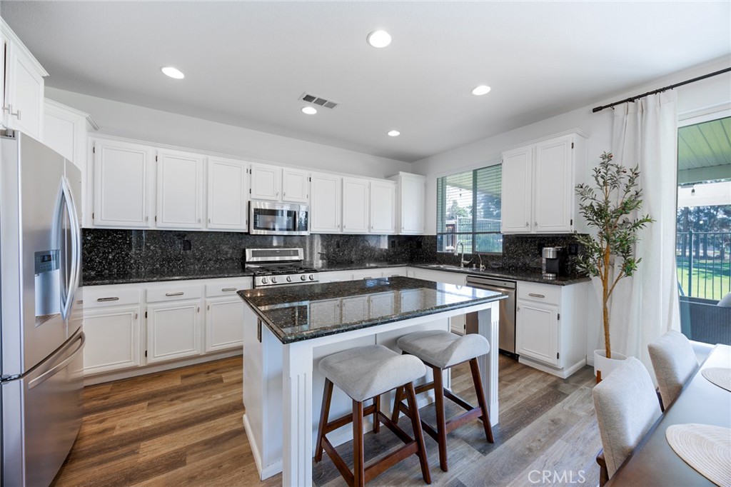 33345 Wallace Way Yucaipa, CA 92399 - Photo 13 of 38 a kitchen with granite countertop white cabinets and white appliances