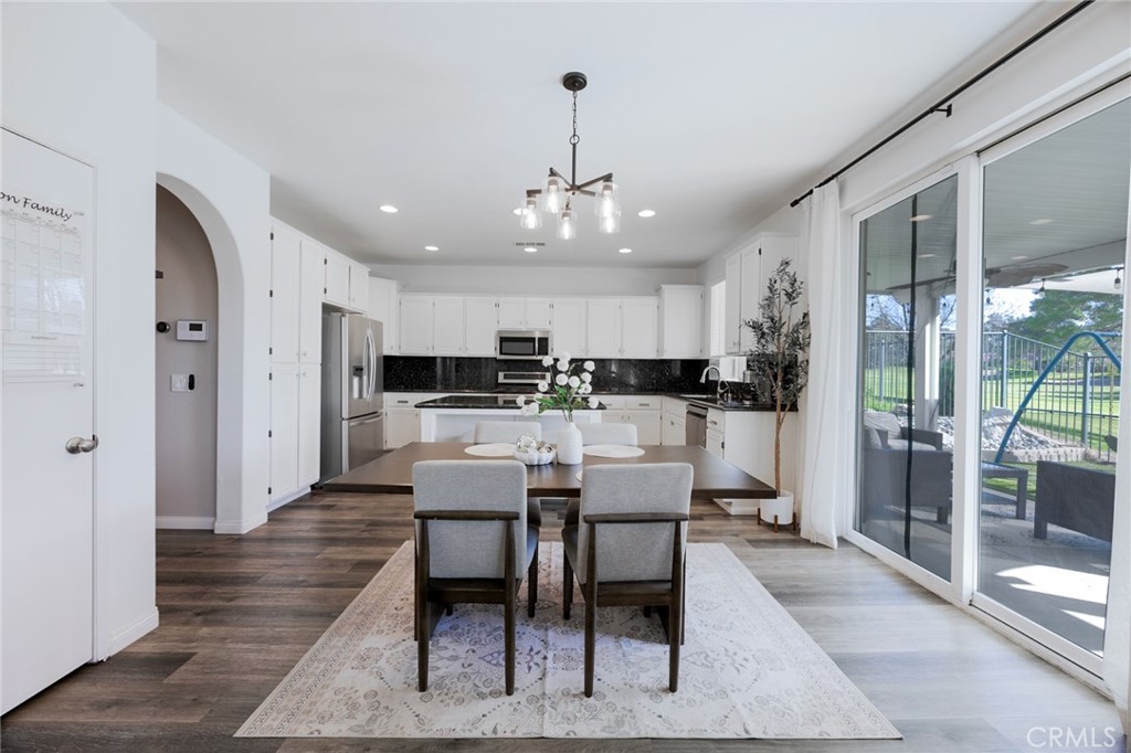 33345 Wallace Way Yucaipa, CA 92399 - Photo 17 of 38 a kitchen with stainless steel appliances kitchen island granite countertop a dining table chairs sink and cabinets