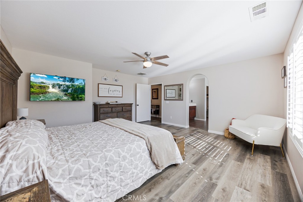 33345 Wallace Way Yucaipa, CA 92399 - Photo 23 of 38 a spacious bedroom with a bed and a couch