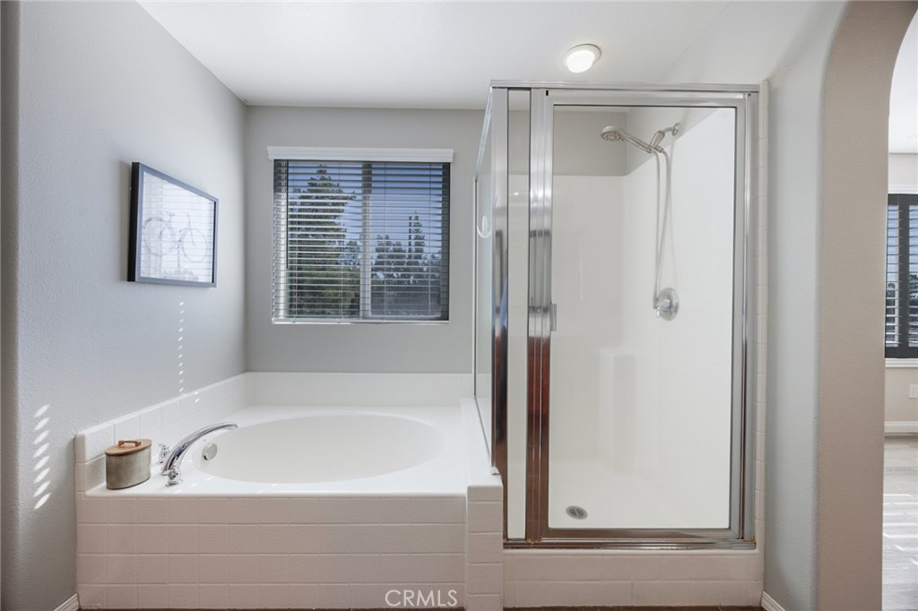 33345 Wallace Way Yucaipa, CA 92399 - Photo 26 of 38 a bathroom with a bathtub and a shower