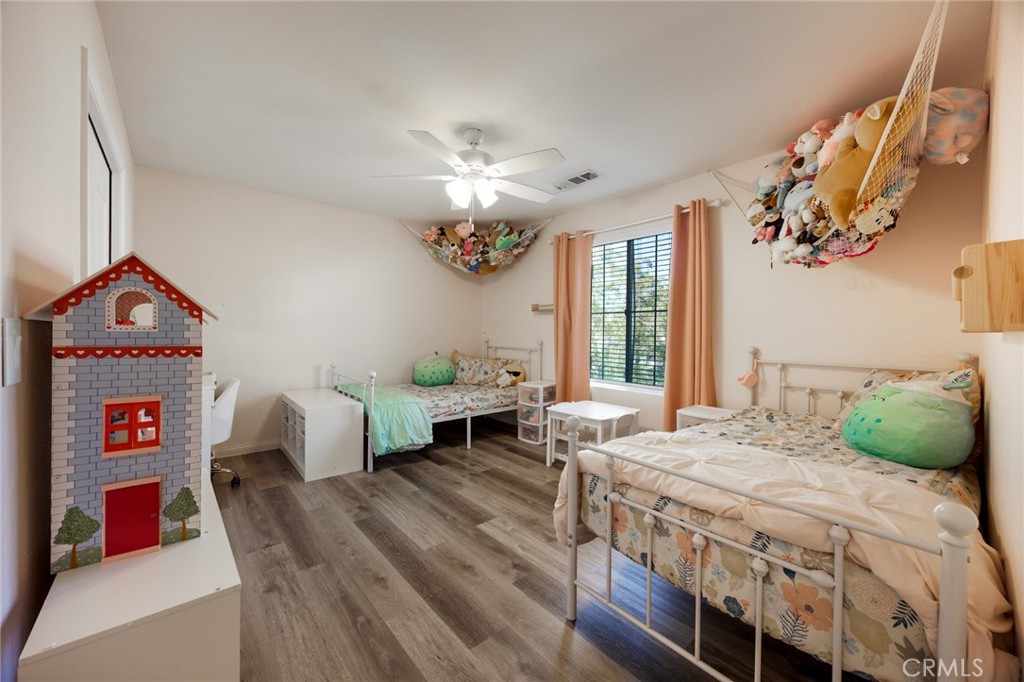 33345 Wallace Way Yucaipa, CA 92399 - Photo 28 of 38 a bedroom with a bed table closet and a window