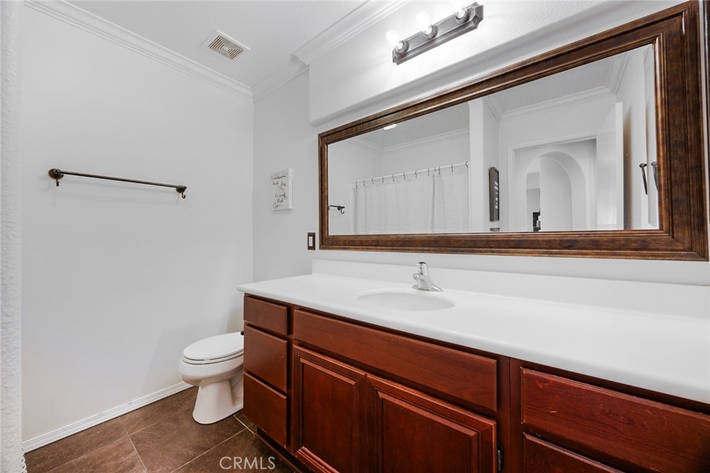 33345 Wallace Way Yucaipa, CA 92399 - Photo 31 of 38 a bathroom with a toilet sink and mirror