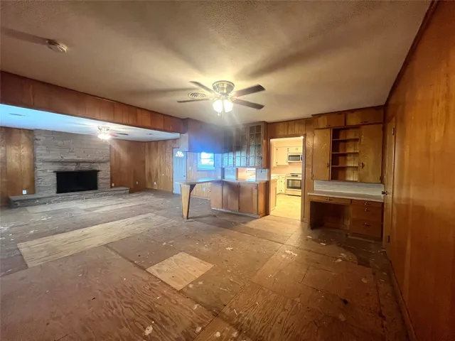 a view of a livingroom with a kitchen and a stove