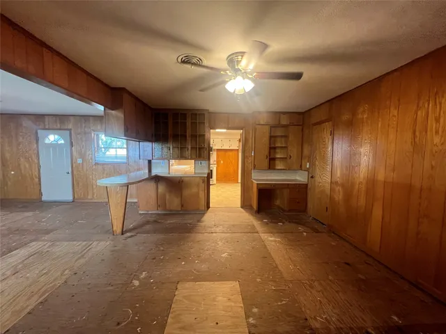 a view of a kitchen with a sink and a refrigerator