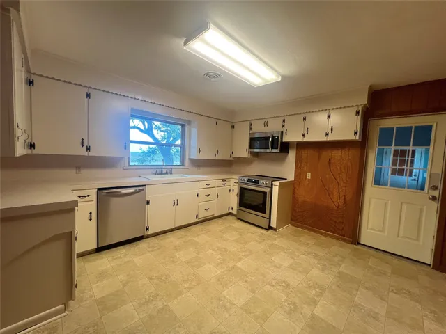 a kitchen with a stove a sink and a refrigerator